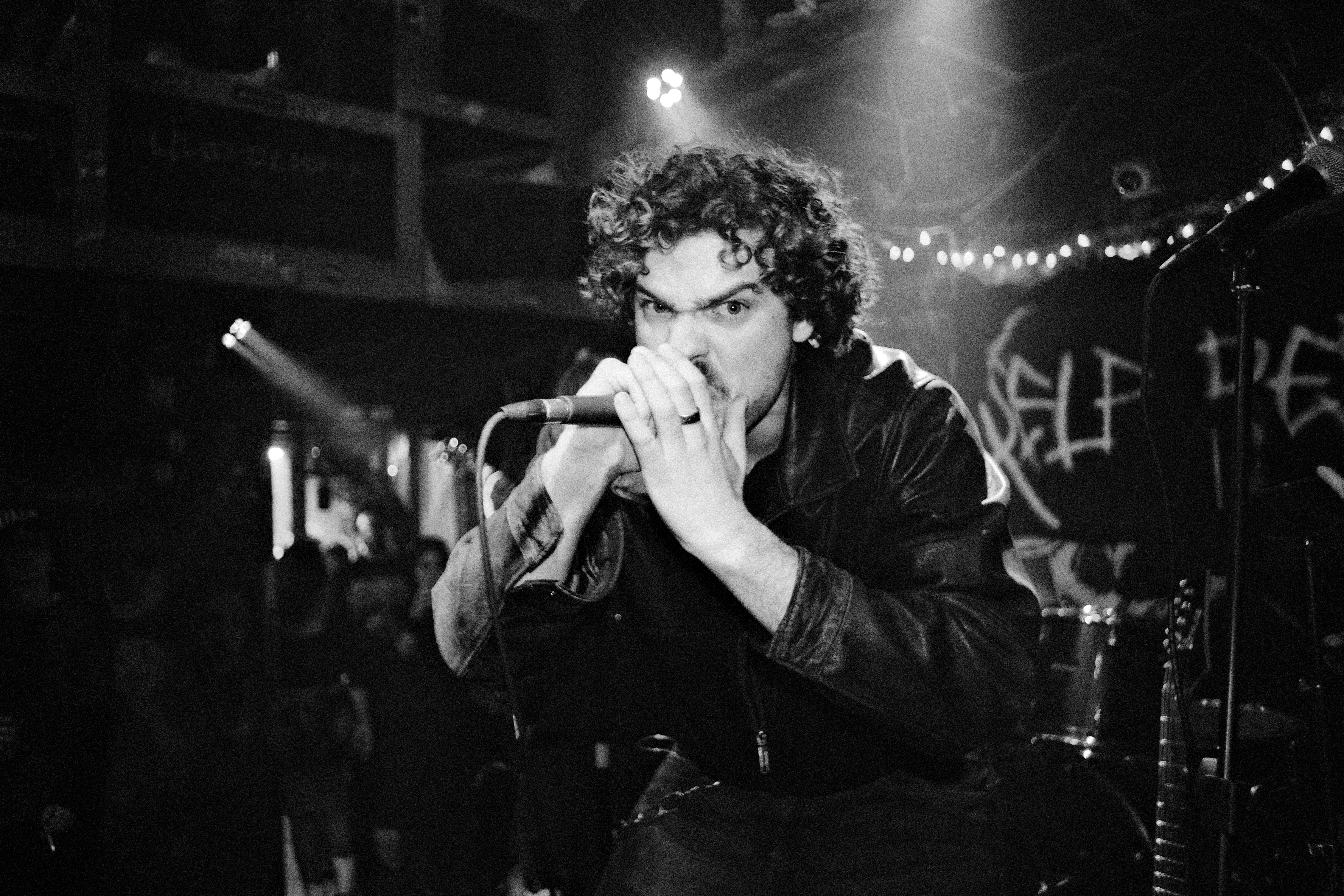 Lead singer yelling into a microphone